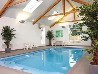 a swimming pool in a house with a roof at Holiday Home Haven by Interhome in Perranwell