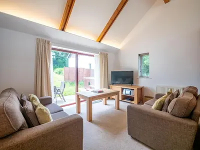 a living room with two couches and a television at Holiday Home Haven by Interhome in Perranwell