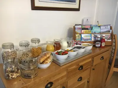 a table with many dishes of food on it at Bridge House Bed & Breakfast in Boscastle