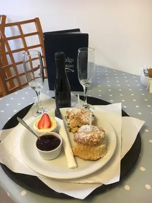 a plate of food on a table with wine glasses at Bridge House Bed & Breakfast in Boscastle