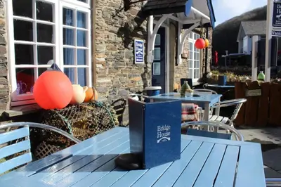 a blue picnic table with a book on top of it at Bridge House Bed & Breakfast in Boscastle