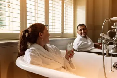 a man and a woman sitting in a bath tub at The Alverton in Truro
