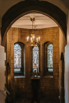 a room with a chandelier and stained glass windows at The Alverton in Truro
