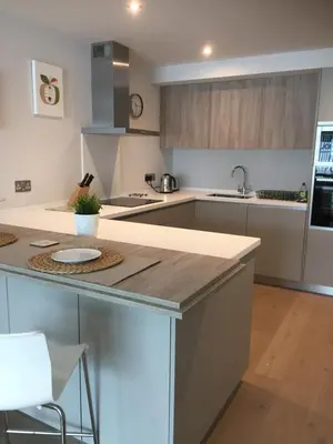 a kitchen with a large island with a counter top at Saltwater Suites at Fistral in Newquay