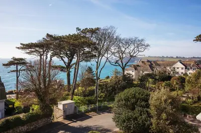 an aerial view of houses and the ocean at Chelsea House Holiday Apartments in Falmouth