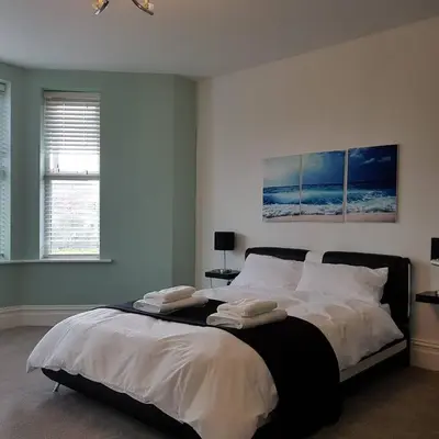 a bedroom with a bed with two pillows on it at Tippy's Guesthouse in Newquay