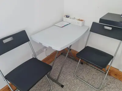 two chairs and a white table in a room at Tippy's Guesthouse in Newquay
