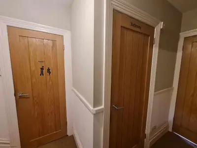 a hallway with two wooden doors in a room at Tippy's Guesthouse in Newquay