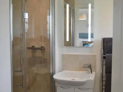 a bathroom with a sink and a shower at Moonraker in Port Isaac