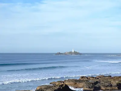 a lighthouse on an island in the ocean at Heatherstone in Illogan