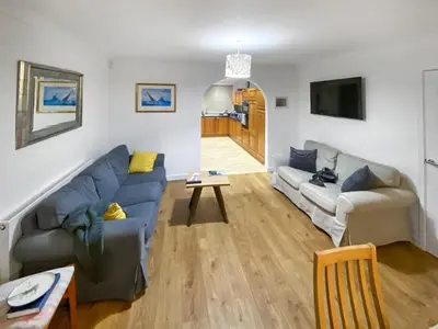 a living room with a couch and a table at Heatherstone in Illogan