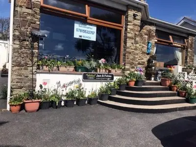 a store with potted plants in front of a building at Aquarius B&B in Newquay