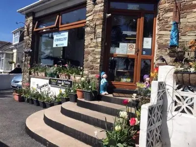 a store front with stairs in front of a building at Aquarius B&B in Newquay