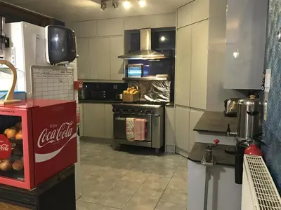 a kitchen with a cocacola machine in a kitchen at Aquarius B&B in Newquay