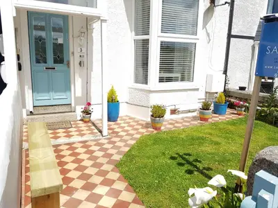a front door of a house with a checkered floor at Saltwater in St Ives