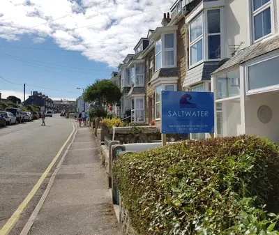 a blue sign for a mailbox on the side of a street at Saltwater in St Ives