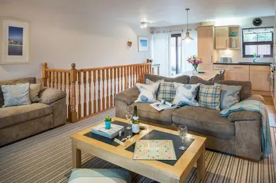 a living room with two couches and a coffee table at Sunnyside Cottage in Crantock