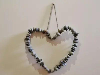 a heart made of beads hanging on a wall at Sunnyside Cottage in Crantock