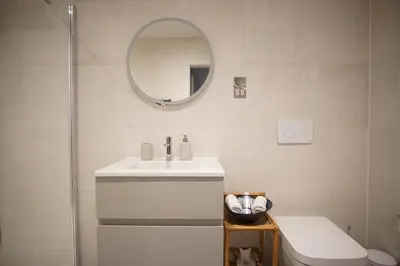 a bathroom with a sink and a mirror and a toilet at Saltwater Newquay in Newquay