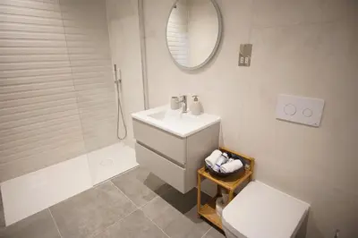 a bathroom with a sink and a toilet and a mirror at Saltwater Newquay in Newquay