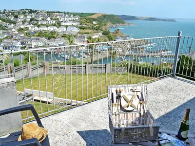 a room with a balcony with a view of the ocean at Berlewen - Ukc3536 in Mevagissey