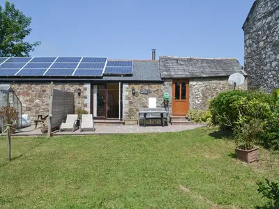 a house with solar panels on the roof at Welly's Wallow in Saint Kew