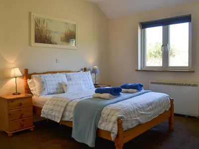 a bedroom with a bed with blue stuffed animals on it at Welly's Wallow in Saint Kew