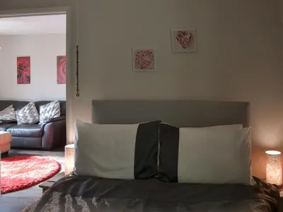 a bedroom with a bed with pillows and a couch at Westville By The Stream in Saint Cleer