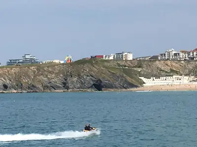 a person on a boat in the water near a beach at Ocean View Beach Rd in Newquay