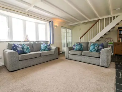 two couches in a living room with blue pillows at Bayview in Newquay