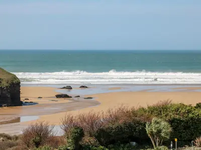 a sandy beach with the ocean in the background at Bayview in Newquay