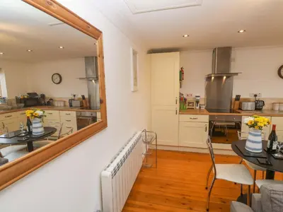 a large mirror in a kitchen with a table at Godrevy Barn in Hayle
