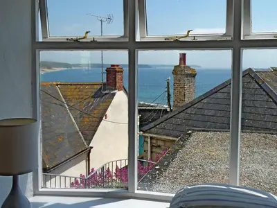 a window view of the ocean from a house at Rosa Cottage in Porthleven