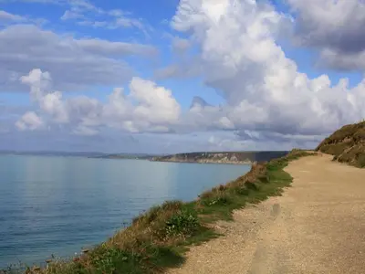 a dirt road next to a large body of water at Rosa Cottage in Porthleven
