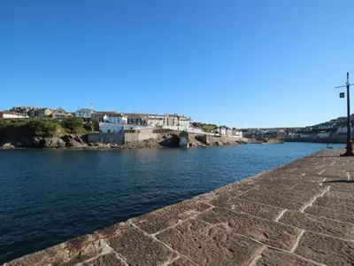 a view of a river with buildings in the background at Rosa Cottage in Porthleven