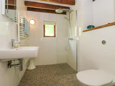 a bathroom with a shower and a sink and a toilet at Oaklands in Camelford