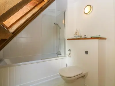 a bathroom with a toilet and a bath tub at Oaklands in Camelford