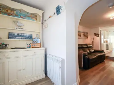 a living room with a couch and a table at Alma House 2 in Perranporth