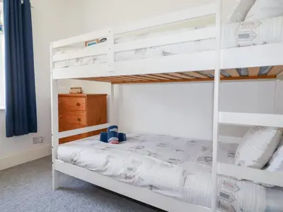 a bunk bed in a bedroom with a white bunk bed at Alma House 2 in Perranporth