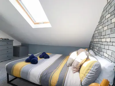 a bedroom with a bed with blue towels on it at Alma House 2 in Perranporth