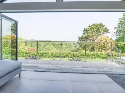 an open living room with a large glass window at Trenant View in Wadebridge