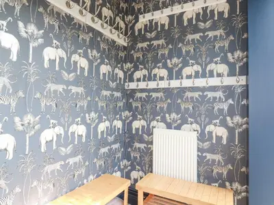 a dining room with a blue and white patterned wall at Trenant View in Wadebridge
