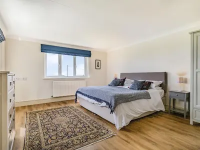 a bedroom with a bed and a window at Penhallick House in Tintagel