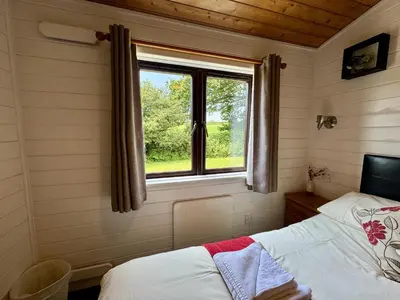 a bedroom with a window and a bed in it at Willow Lodge in Falmouth