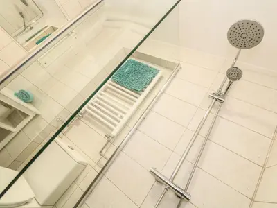 a shower with a glass door with a sink and a shower at Gull Rock in Tintagel