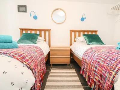 two beds sitting next to each other in a bedroom at Gull Rock in Tintagel