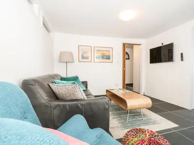 a living room with a couch and a table at Gull Rock in Tintagel