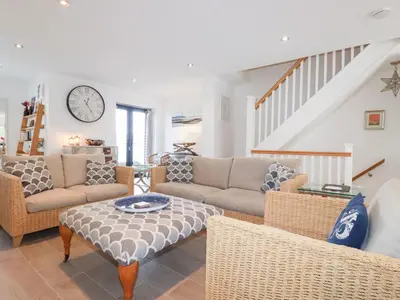 a living room with a couch and a table at Seaspell Beach House in Padstow