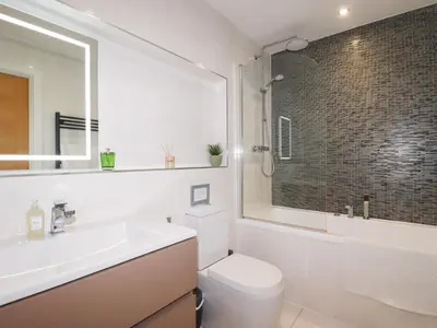 a bathroom with a toilet and a sink and a shower at Seaspell Beach House in Padstow