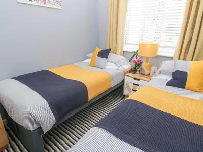 a bedroom with two beds and a window at Tranquility in Falmouth